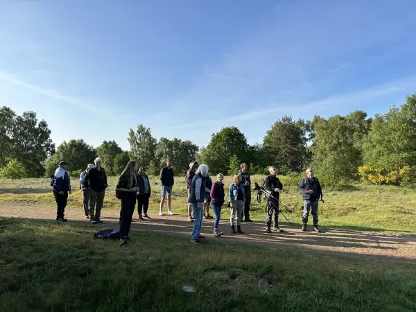 A group of people in nature on a bird walk